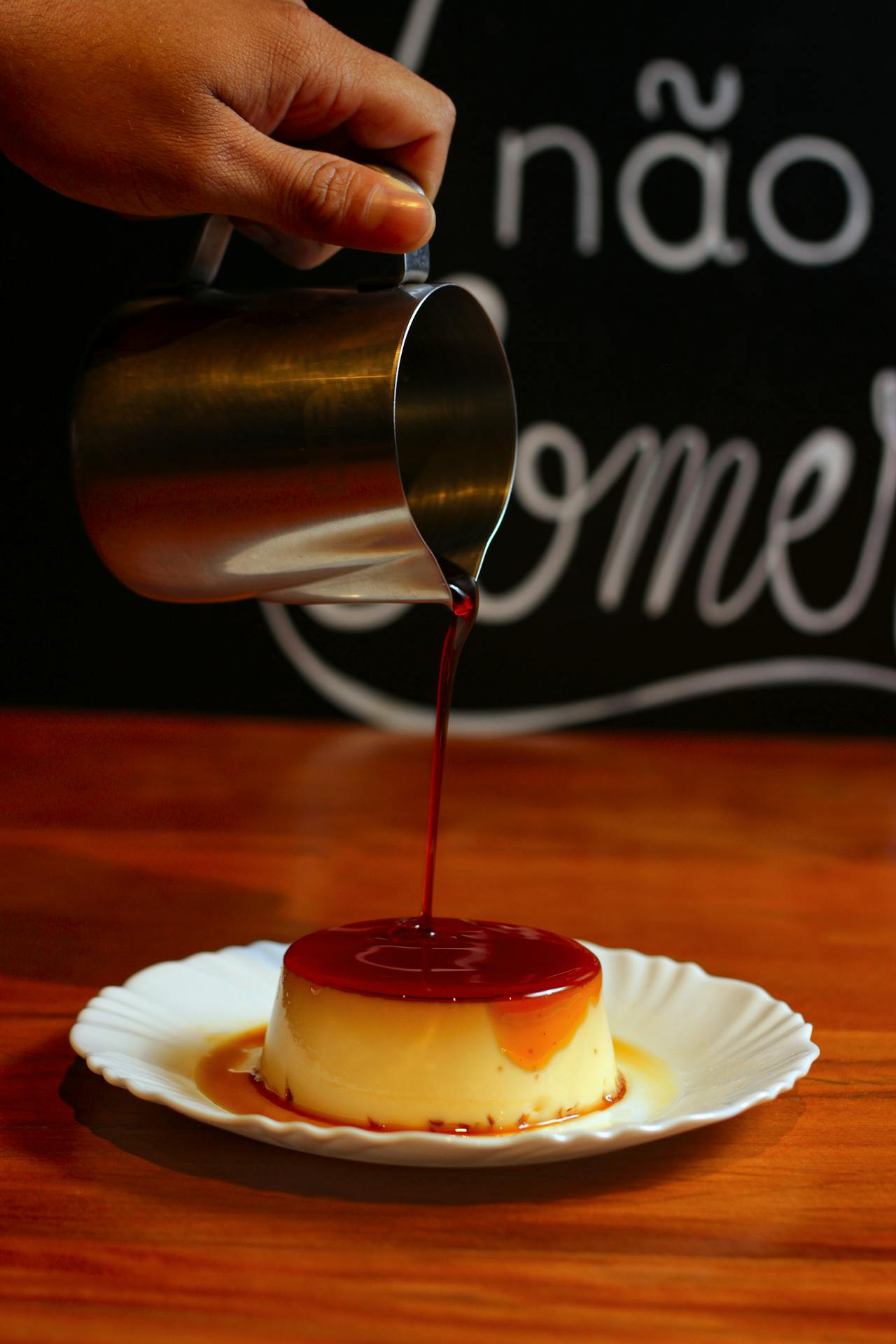 pouring sauce on flan